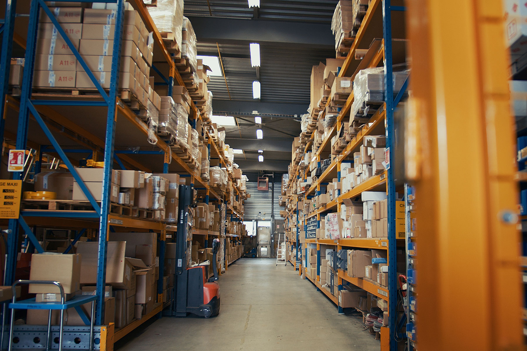 Page Image Warehouse Racking in Orange and Blue Stocked with Boxes