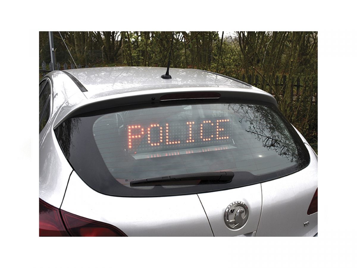 Traffic Commander - Programmable LED Matrix Display In Situ in Back Window of Silver Vauxhall Showing Police Message