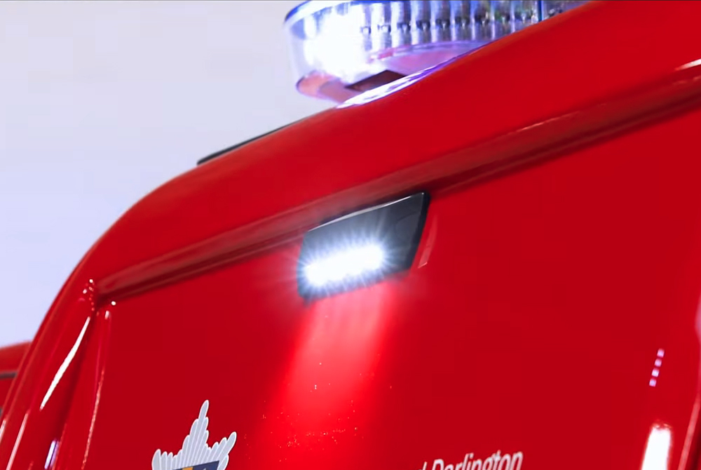 Close up of vehicle scene light and lightbar both lit on red vehicle