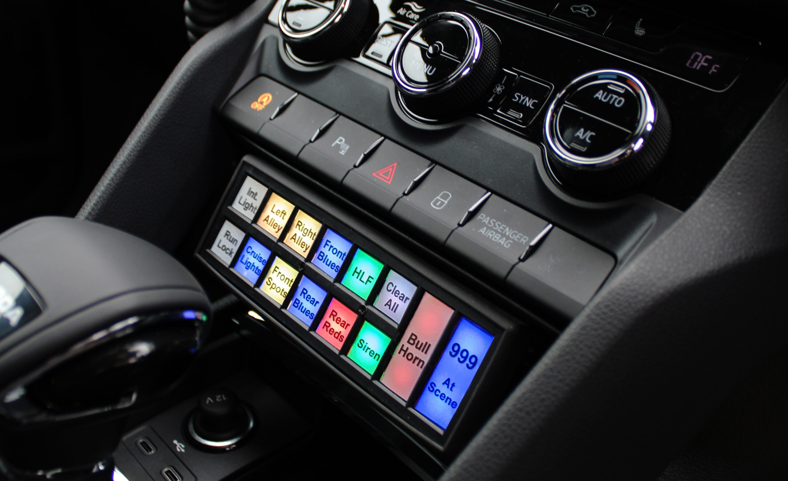 Close Up Shot of Handset Mounted Under Vehicle Dash with Buttons Lit in Various Colours