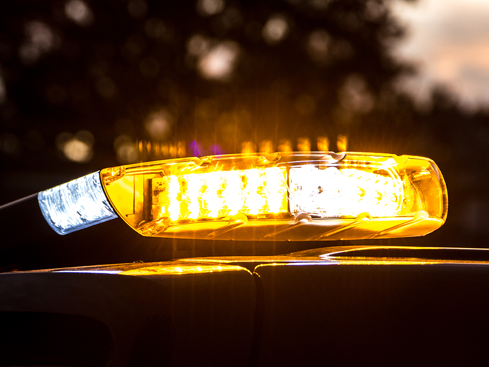 Closely cropped image of the W3 lightbar on top of a vehicle at night with amber lights on