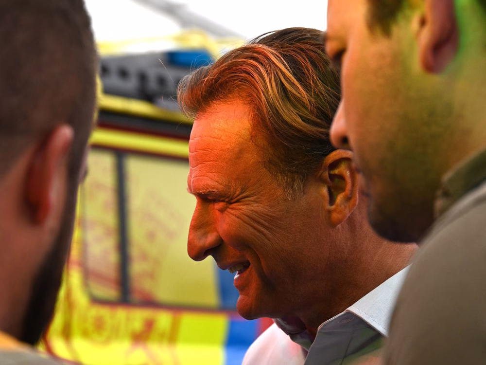 Over the shoulder shot of stand visitors and a Standby employee. Closely cropped and candid.