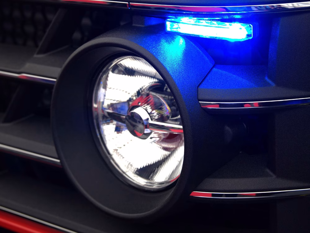 Blue LED module above a headlight on a show vehicle.