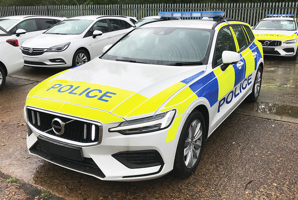 Thames Valley Police Volvo V60 Standby Installation Angle View in Front of Marked and Unmarked White Police Cars with One Grille Light Lit