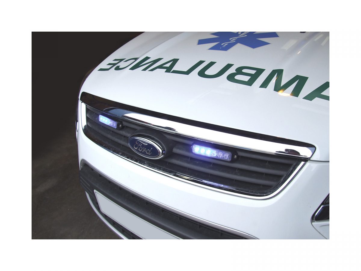 Mini Stealth - 6-way Horizontal Surface Mount LED Modules Mounted in Grille of Ambulance, Both Partially Blue Lit