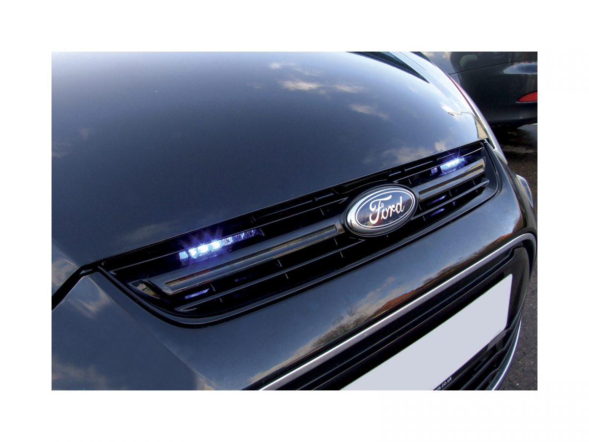 Mini Stealth - 6-way Horizontal Surface Mount LED Modules Mounted in Grille of Black Ford, Both Lit Blue