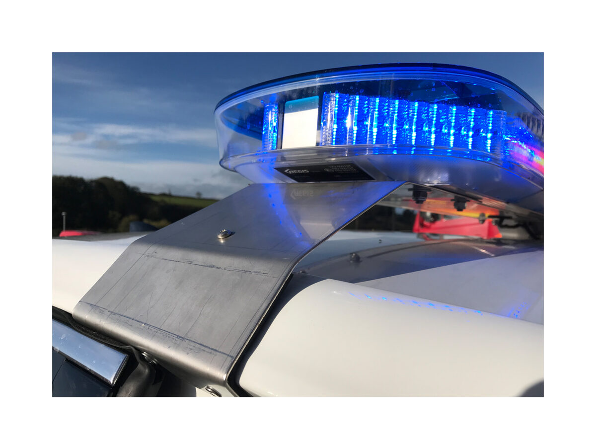 Aegis LED Lightbar In Situ Lit Blue and Red Closeup on top of White Car Roof