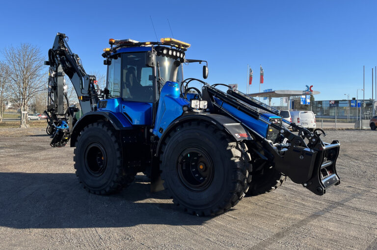 Angle View of Blue Excavator with Various Amber LED Modules and Amber W3 Lightbar with Blue Sky in Background