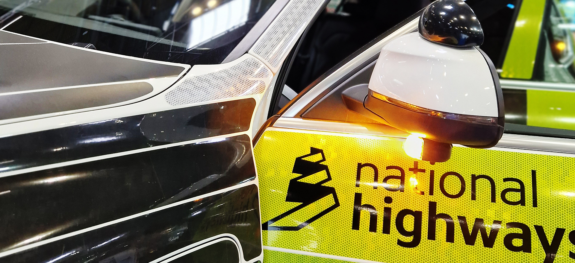 Close up of National Highways Vehicle with Amber Light mounted underneath Wing Mirror