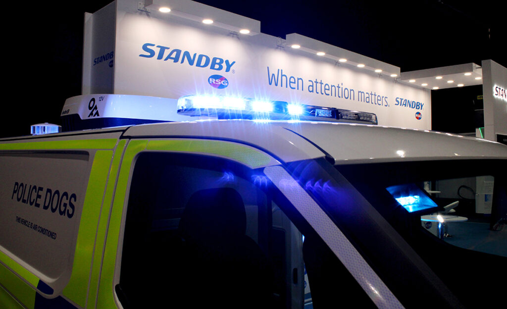 Close up of Lightbar lit blue on top of police van on Standby RSG's NAPFM stand
