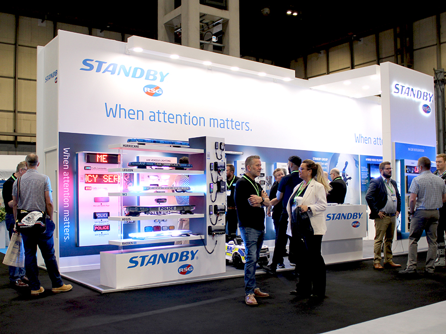 Standby RSG stand at The Emergency Services Show 2023 with groups of people crowded around.