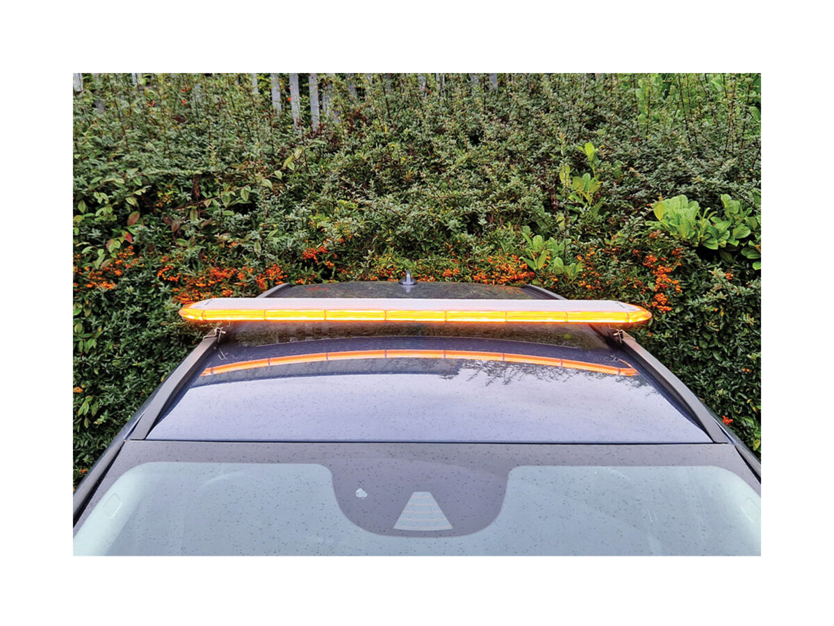 LB200 Amber front view in situ on dark car roof in front of hedge.
