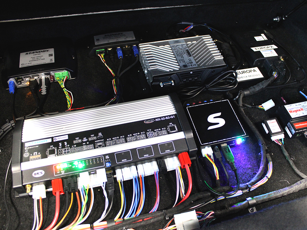 Close up of in boot equipment installation, angle view with neat wiring and labelling.