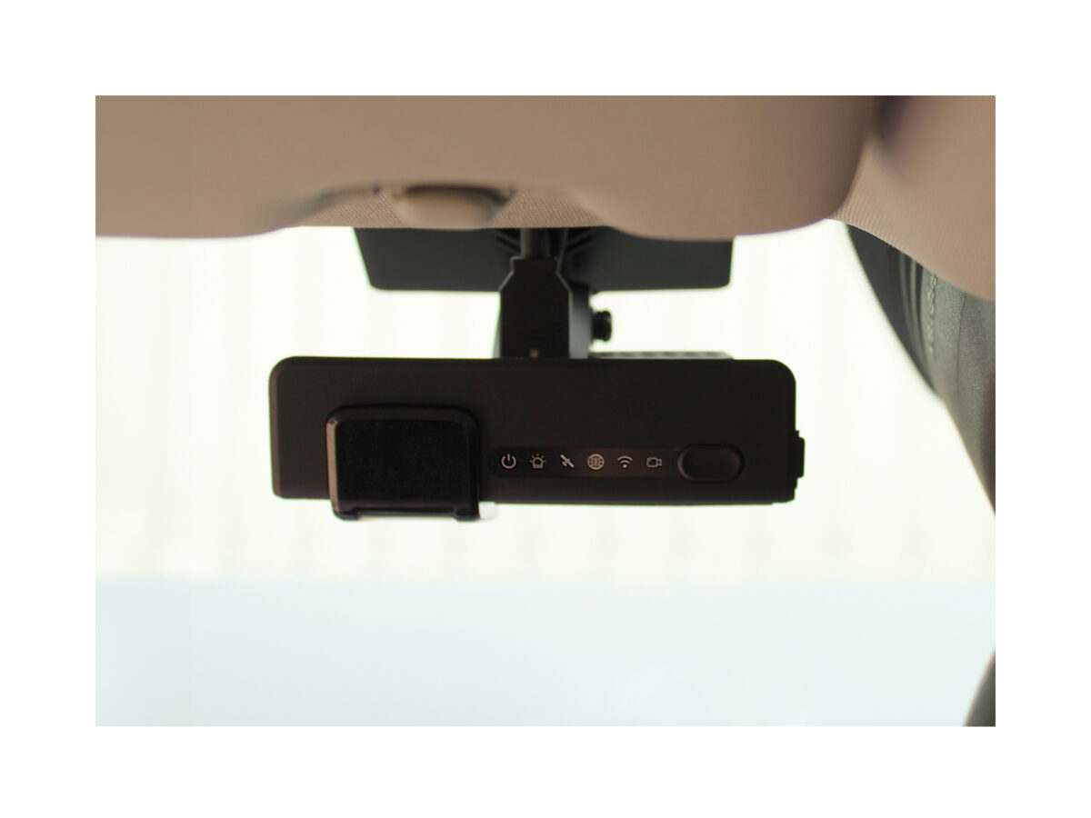 Rear shot of the Mini Dashcam mounted on a vehicle windscreen, closely cropped and taken from the passenger seat.