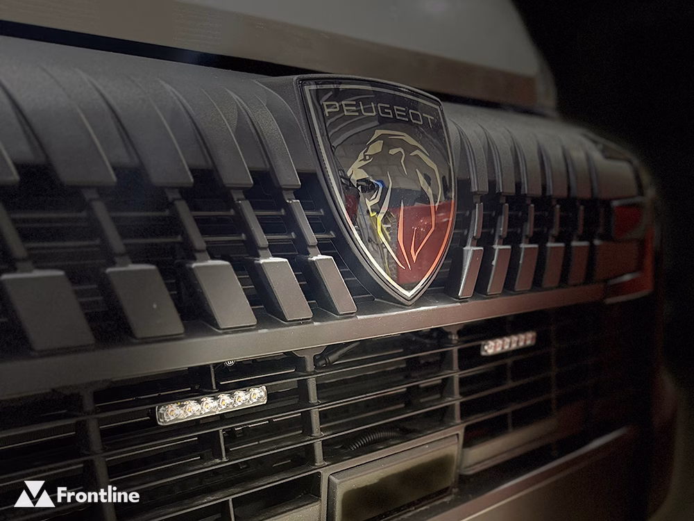 Close up of vehicle grille with 2 unlit Edge Dagger LED modules and a Peugeot badge between them
