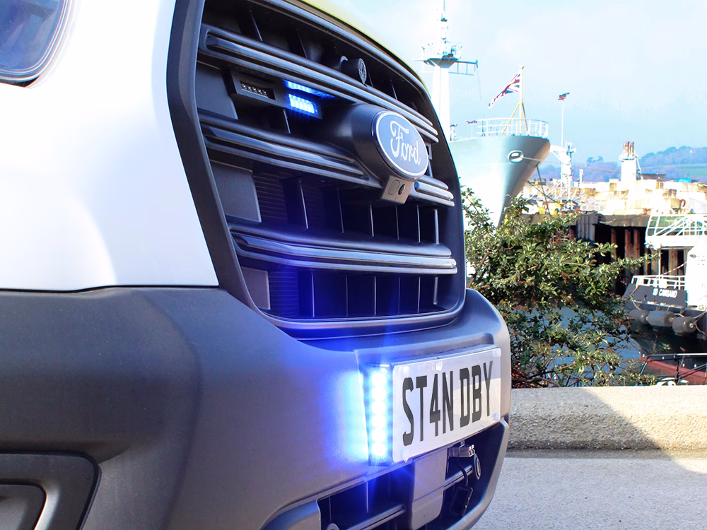 Closely cropped angle view of a Closely cropped shot of a HM Coastguard Ford Transit OSV showing the vehicle grille with Stealth Reg Plate and Edge Dagger LEDs.