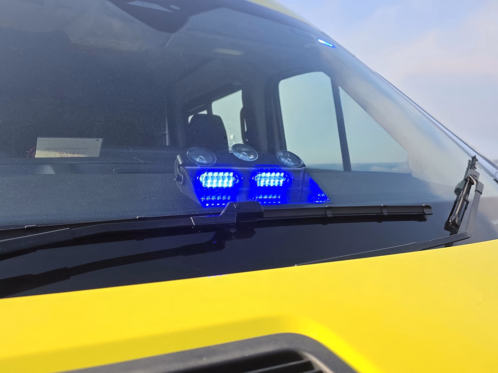 Titan Dash module shown on a closely cropped angle view of a HM Coastguard Ford Transit OSV, lit in blue.
