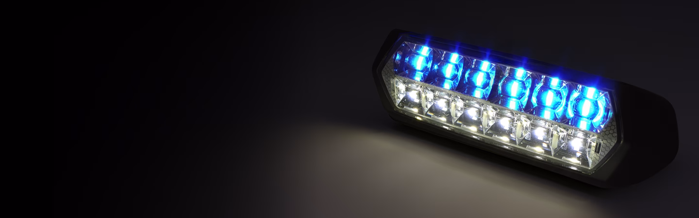 Blue and white SceneMax shown at an angle lighting up a dark background