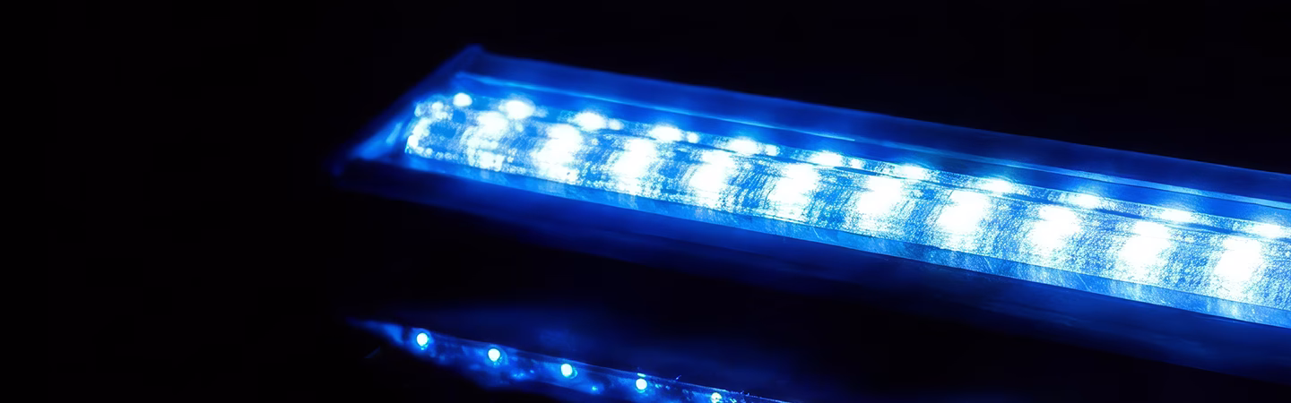 Blue FlexiScreen LED module on a glossy black surface with reflecting lights