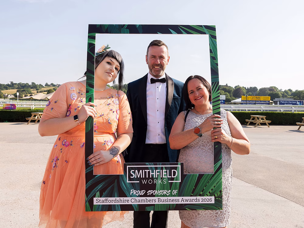 Standby UK representatives hold and pose behind a 'Smithfield Works' photo frame at Staffordhsire Chambers Business Awards 2026 wearing black tie attire.