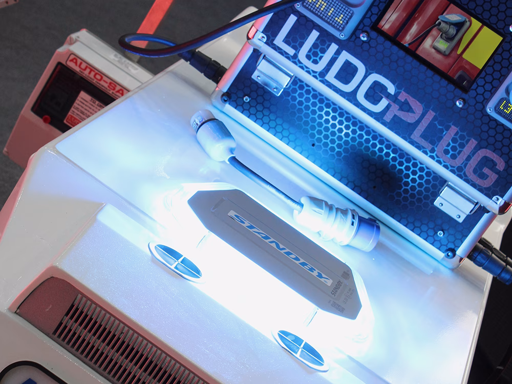 Close up angle shot of the Standby LB200 Lightbar in blue, on top of a scaled down ambulance on the Ludo Mcgurk stand at NAPFM 2026.